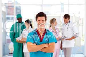 Attractive doctor with is team in the background