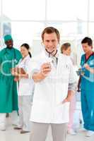 Young doctor with stethoscope and his team