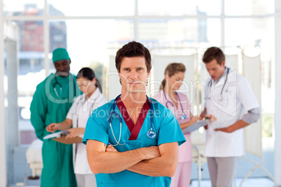 Cofident doctor with his team in the background