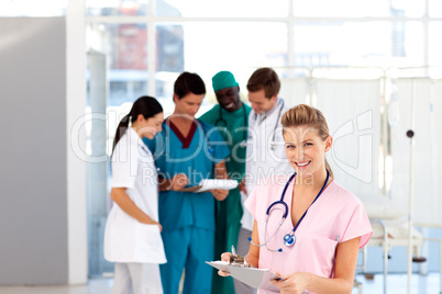 Beautiful nurse with her team in the background