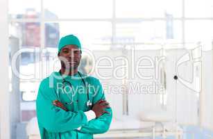 Serious Afro-American surgeon with folded arms