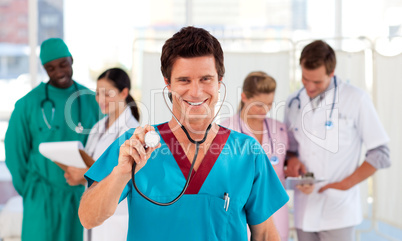 Portrait of a doctor with his team in the background