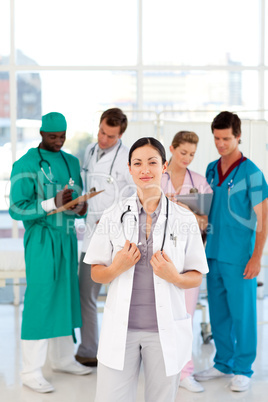 Female doctor with her team in the background