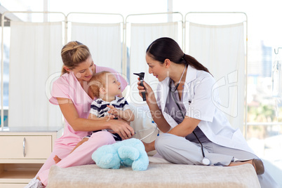 Young doctors attending to a baby