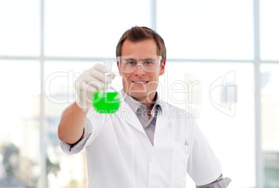 Smiling scientist examining a test-tube