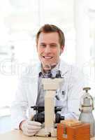 Male scientist looking through a microscope