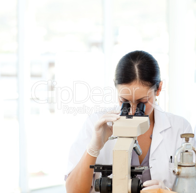 Scientists looking through a microscope