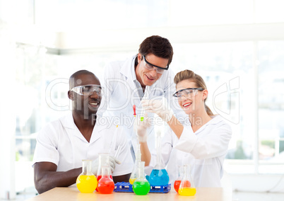 Group of scientists examining test-tubes