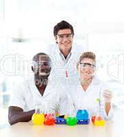 Smiling scientists examining test-tubes