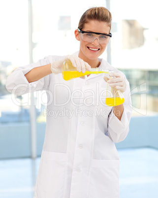 Young female scientist examining a test-tube