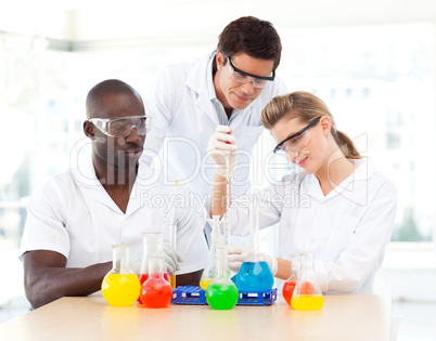 Young scientists examining test-tubes