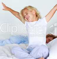 Young child stretching after sleeping