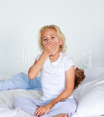 Little girl very tired in bed