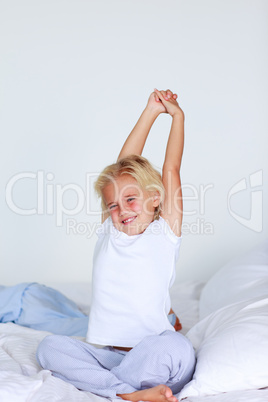 Blonde girl stretching in bed