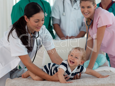 Doctors taking care of a young child