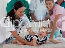 Doctors taking care of a young child