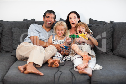 Family on Sofa Playing Video games