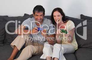 Couple on Sofa Playing Video Games