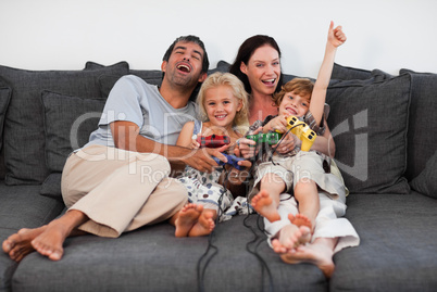 Family on Sofa Playing Video games