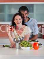 Couple in Kitchen smiling at camera