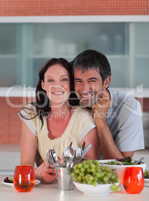 Couple in Kitchen smiling at camera