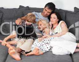 Family on a sofa with laptop