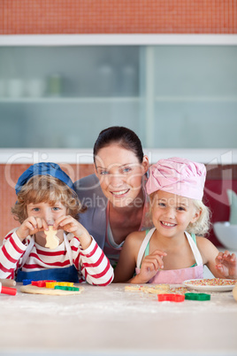 Mother with her Two Kids looking at the camera smiling