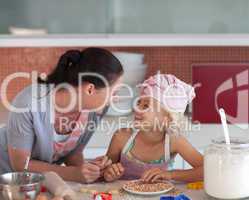 Potrait of mother and Daugther in Kitchen preparing food