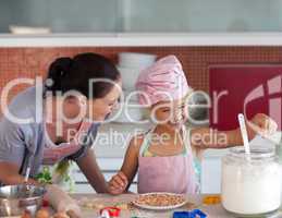 Mother teaching Child how to cook