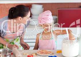 Mother teaching Child how to cook