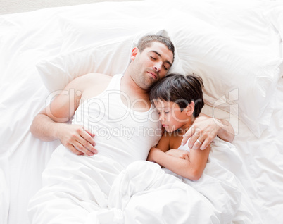 Father and Son Lying on bed