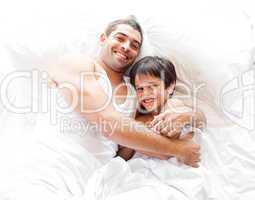 Father and Son Lying on bed