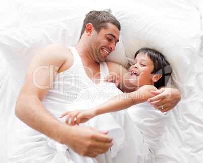 Father and Son Lying on bed