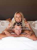 Couple on bed smiling