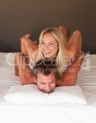 Beautiful woman on a mans back in bed