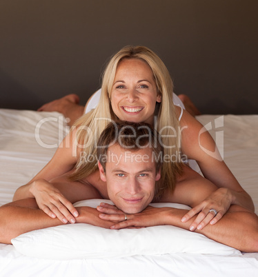 Beautiful woman on a mans back in bed