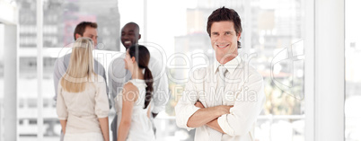 Young Business man Smiling in Front of Business team