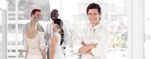 Young Business man Smiling in Front of Business team
