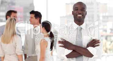 Business leader standing inf front of business team smiling