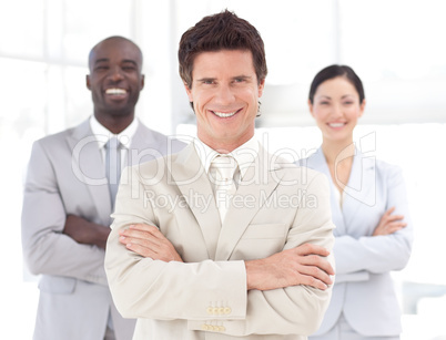 Business man smiling in front of Business team