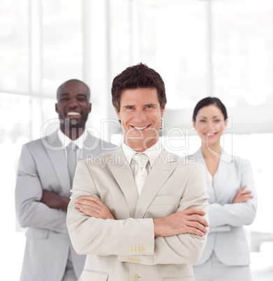 Business man smiling in front of Business team