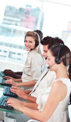 woman smiling at camera in a call centre