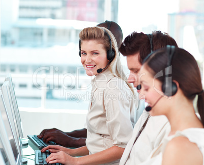 woman smiling at camera in a call centre