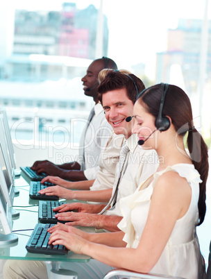 Man in Call centre looking and smiling at camera