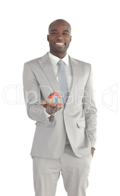 Businessman holding a house in his hands