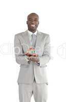 Businessman holding a house in his hands