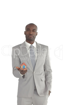 Businessman holding a house in his hands