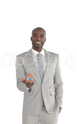 Businessman holding a house in his hands