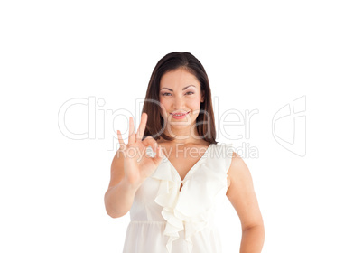 Attractive businesswoman showing okay sign