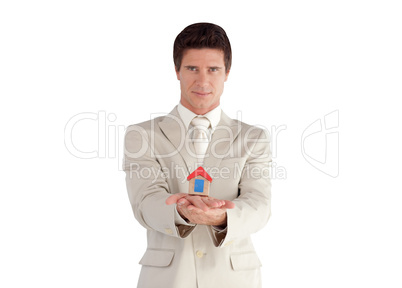 Businessman holding a house